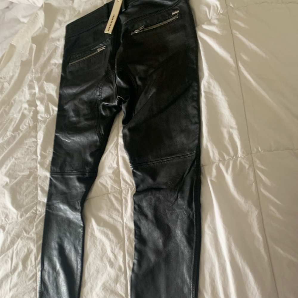 Diesel Leather Pants Mens with front and back pockets with zippers on them.